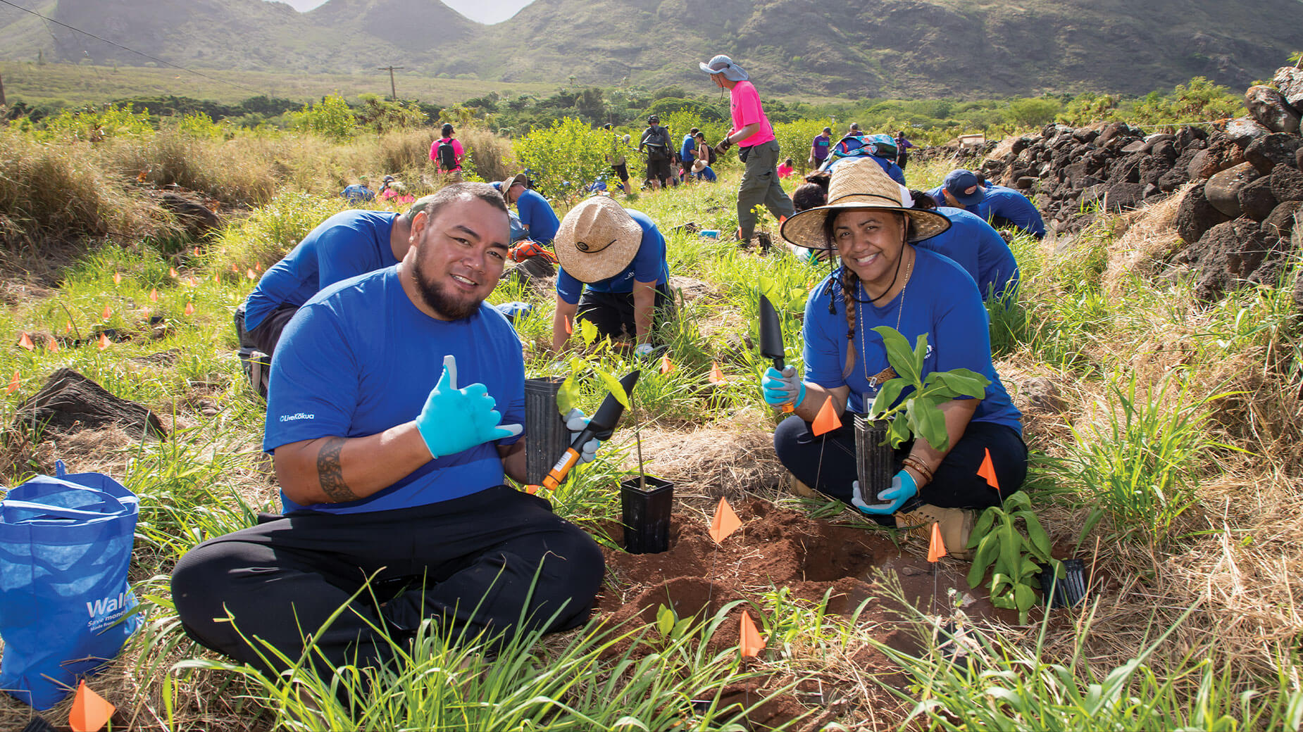 Employee with husband at tree planting community service day