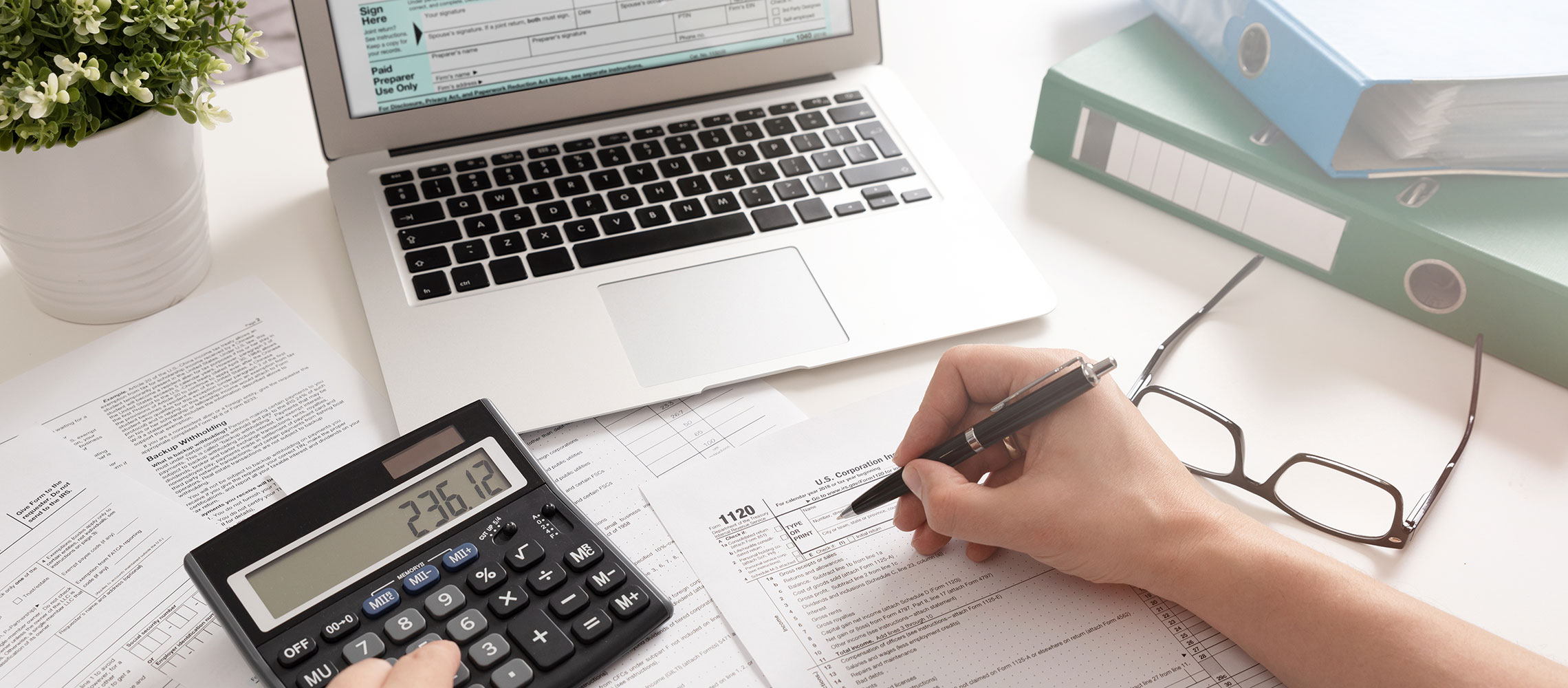 close-up photo of man working on taxes