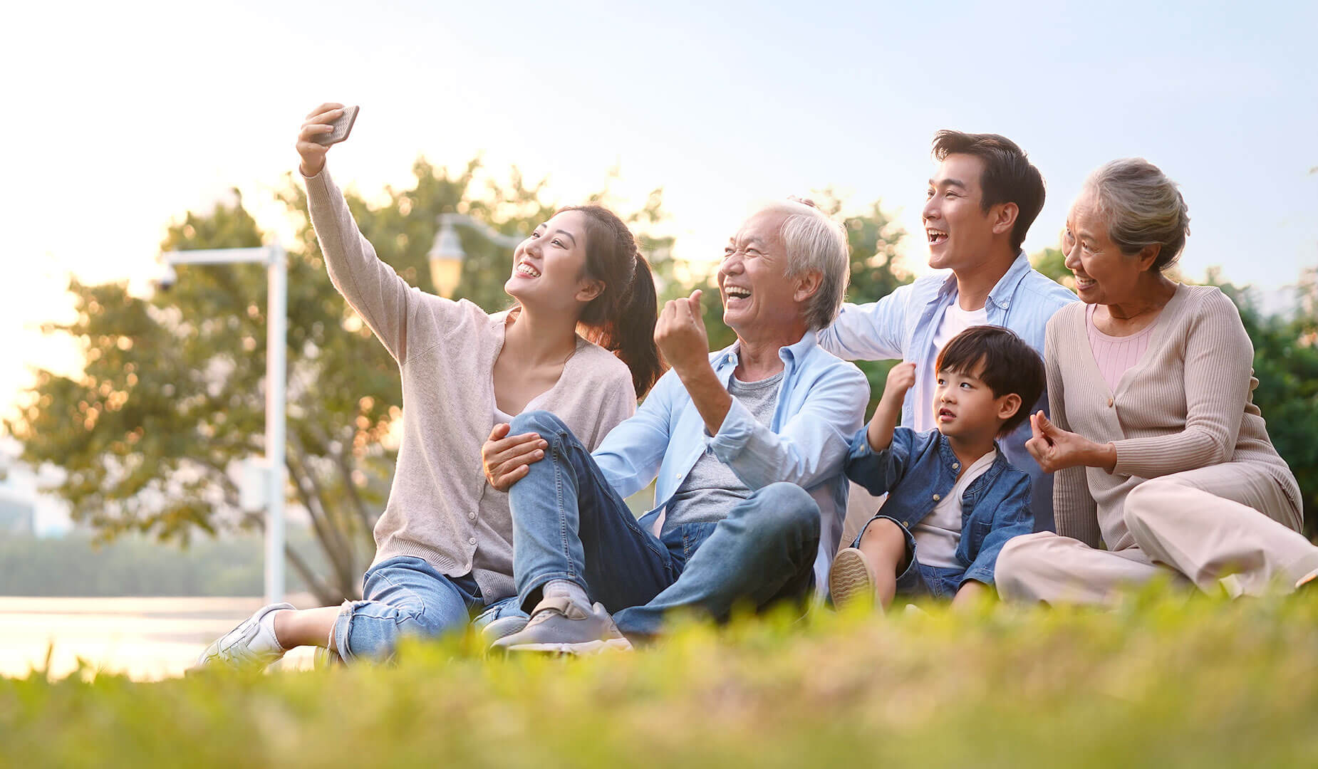 multigenerational family taking a selfie in the park