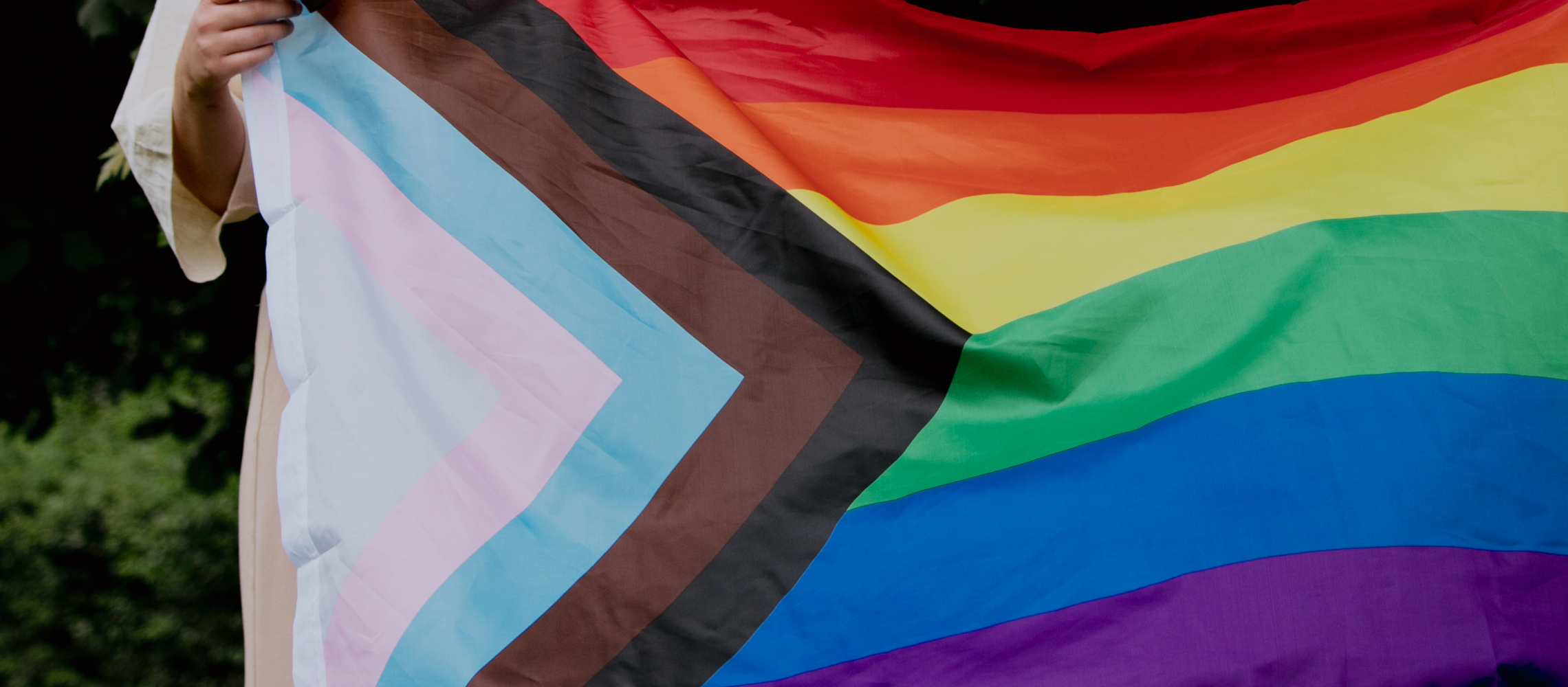 Progress Pride Flag being held up