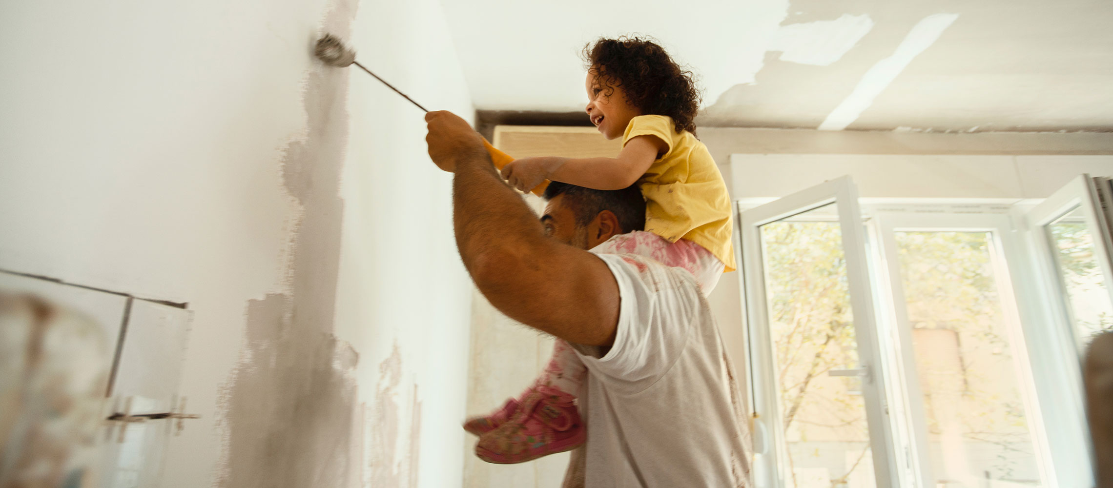 family painting house together