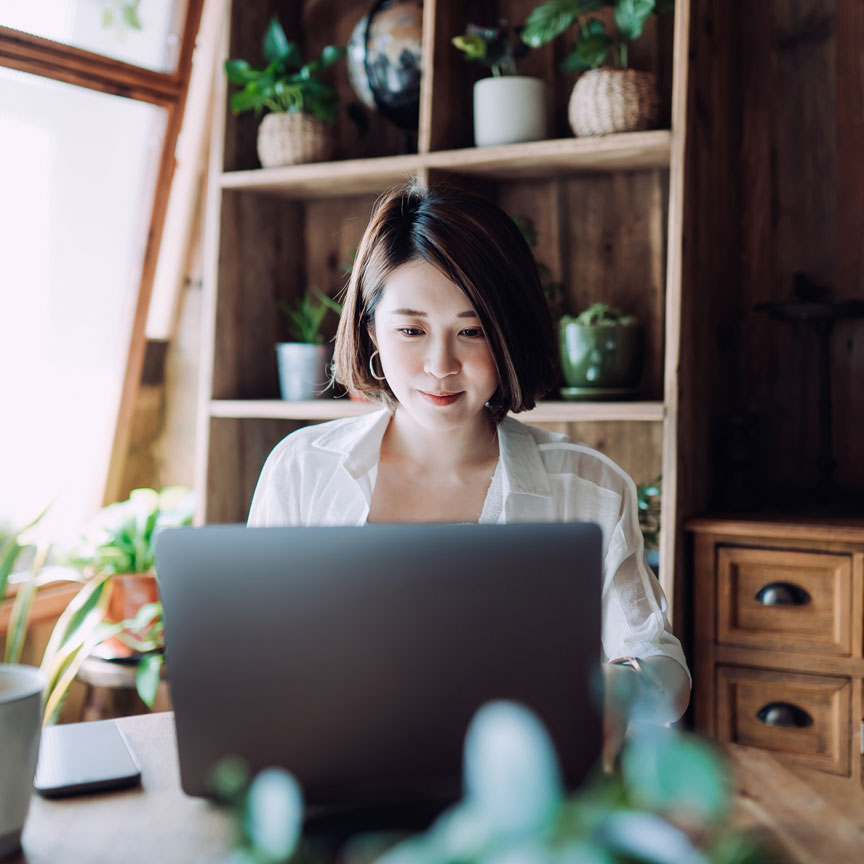 woman working on her laptop in her living room