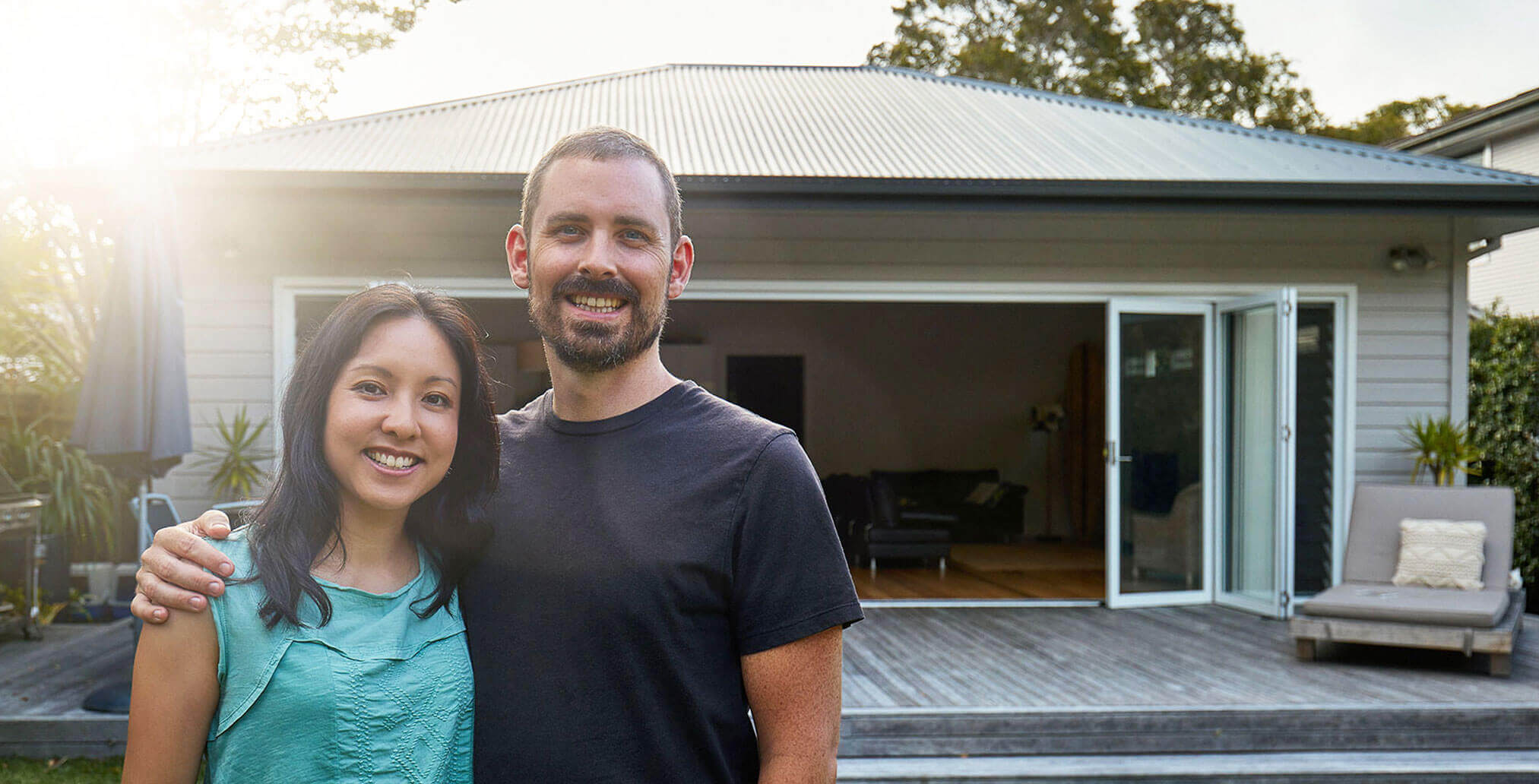 couple with house in background