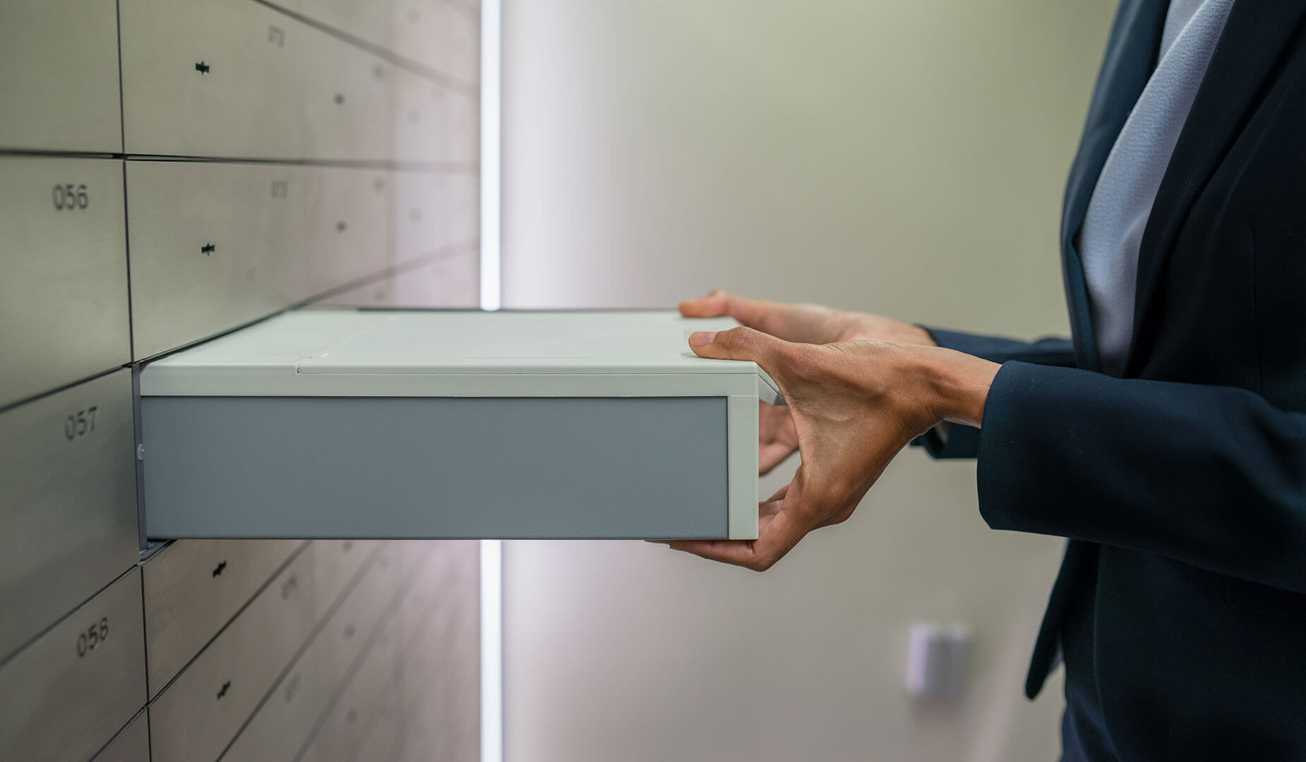 person handling a safe deposit box