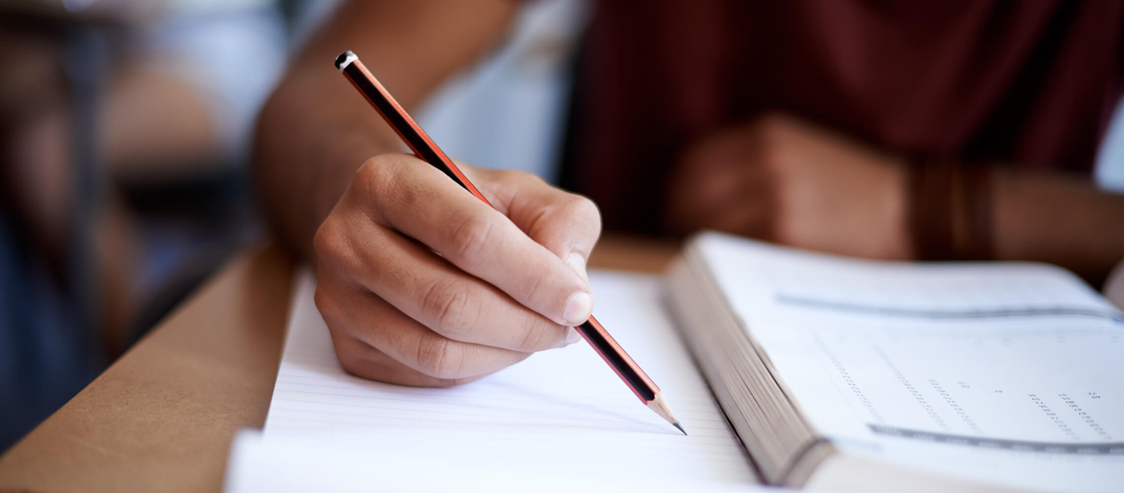 person writing in a notebook