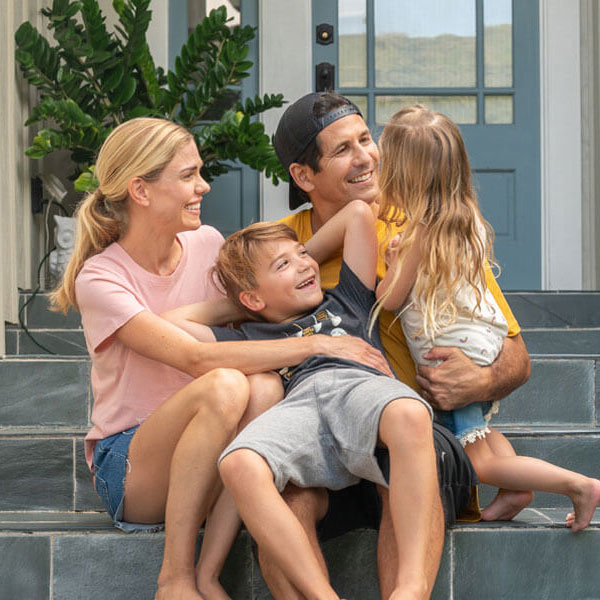 family sitting on the front steps